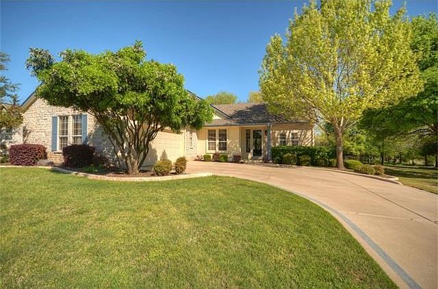 Backing a wide nature preserve dotted with native trees, this delightful Sun City Texas Brazos Premi