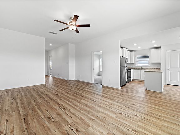 A foyer leads to the family room and adjoining kitchen