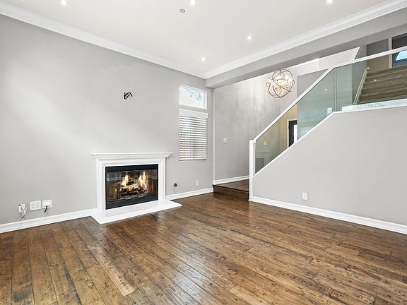 view from living room looking back at the front entry and stairs to bedrooms