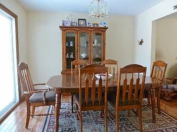 This bright dining room has a patio door leading to the deck and is open to the kitchen and living room.
