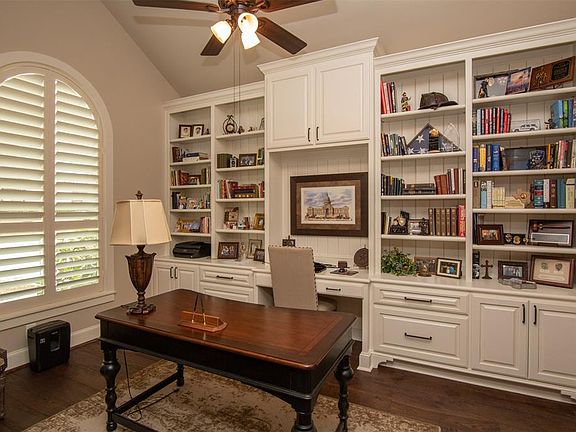 When you enter the home, its rich attention to detail will immediately catch your eye. To the left of the entry you will find this fantastic study with its wall of built in cabinets. You will find lovely plantation shutters in many of the rooms. The 