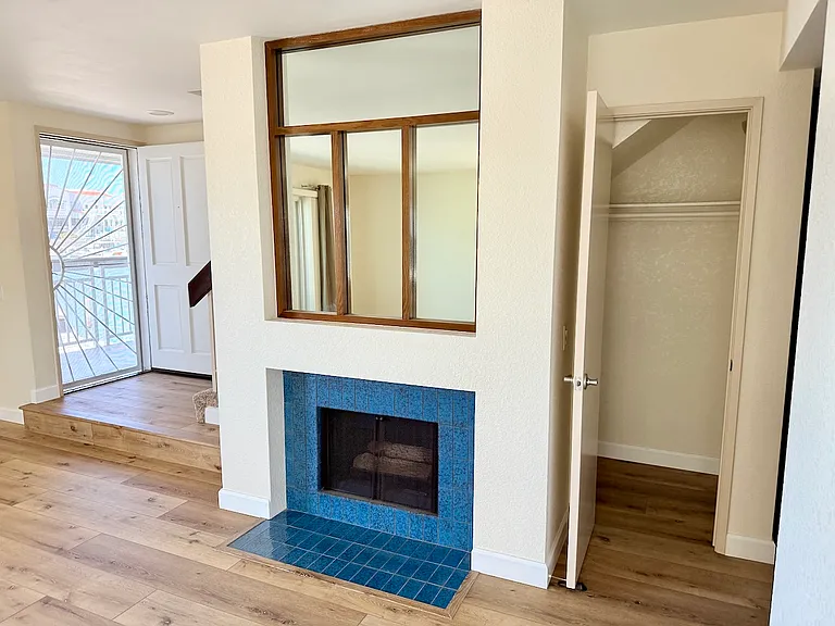 Entry door, fireplace, and coat closet on lower floor.