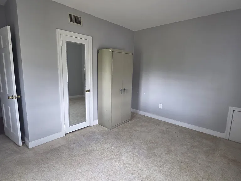 Comfortable bedroom with large windows and roomy closet space.