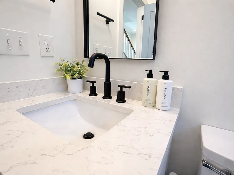 Located off The Krog Suite (downstairs queen bedroom), this spa-inspired bath offers a shower and tub, plush linens, designer interiors, and premium Apotheke products for a true boutique hotel experience.