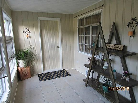 Inviting front porch with attached garage access.