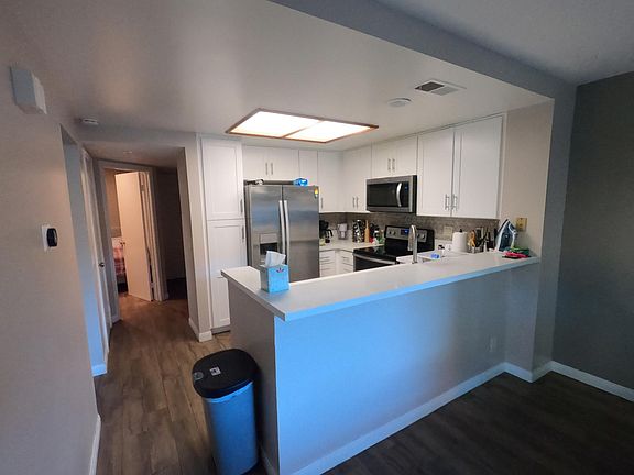 Kitchen and hallway leading to the downstairs bedroom