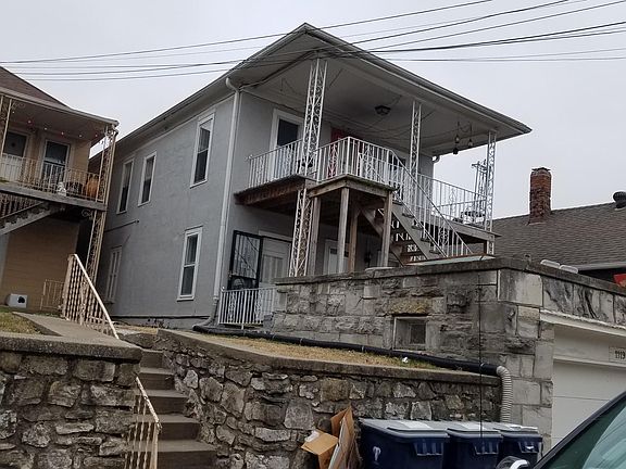Second floor of duplex with covered deck in front.