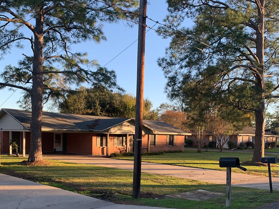 Large Front Yard with 2 car carport and outside storage.