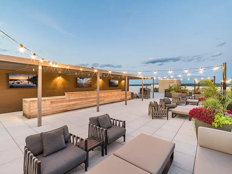 Elevate your entertainment experience with Modera Montville's rooftop deck featuring TVs, where relaxation meets the skyline.