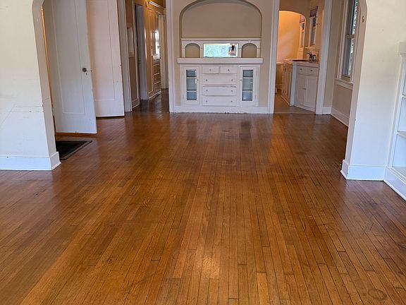 Living room and dining room; many original built-in cabinets