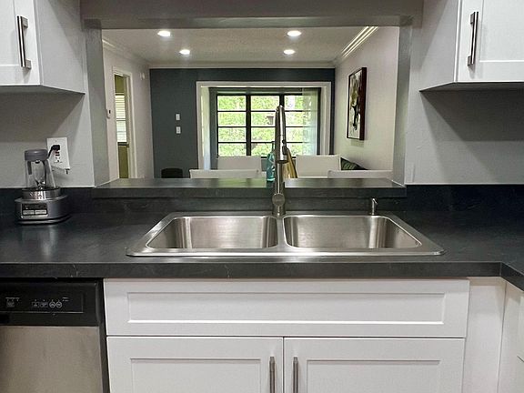 kitchen with pass thru over stainless sink area