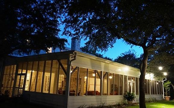 Screened-in patio viewed from outside corner.