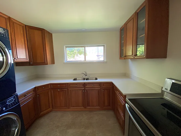 Kitchen: Updated kitchen with beautiful wood cabinets with interior accessories. New quartz countertops, and new vinyl flooring.