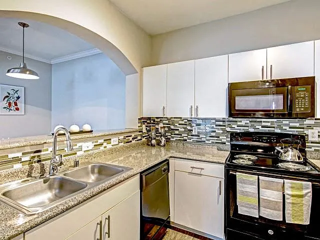 Eat in kitchens with black appliances and white cabinets