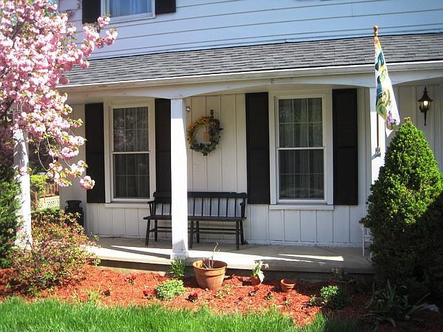 Lovely front porch is charming and inviting