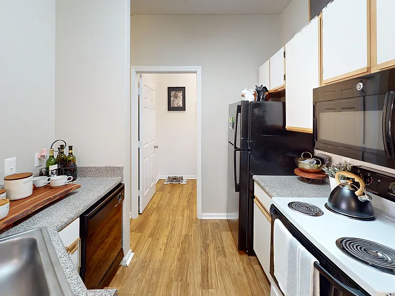 The kitchen includes a dishwasher, built-in microwave, and easy access to your in-unit laundry.