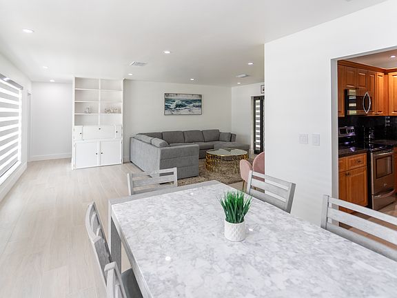 Inside the entrance of house. Dining area, with kitchen to the right and living area ahead