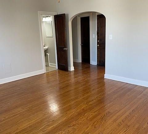 Living room has a half bath off of it and the front door is immediately across from the living room and opens into a long hallway. One direction takes you to two of the bedrooms and a full bath and the other takes you to the other bedroom, kitchen and la