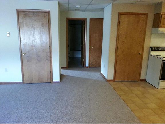 Hallway with coat closest on the left and pantry on the righ