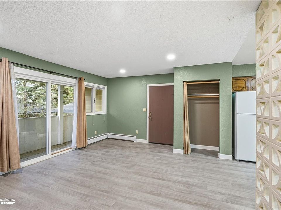 Livingroom. This picture show's front door to the apartment. accessed from front common entry to building. Also show's sliding glass door to front porch.