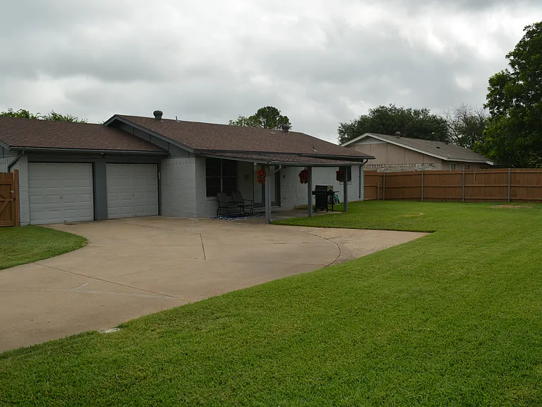 Full-fenced and spacious backyard with a covered patio, outdoor furniture and a grill for outdoor family fun!