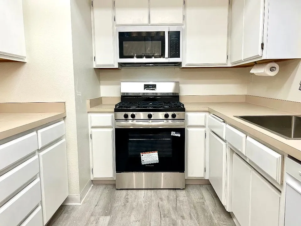 Kitchen with new 5-burner stove & a built in microwave.
new & modern stainless-steel sink