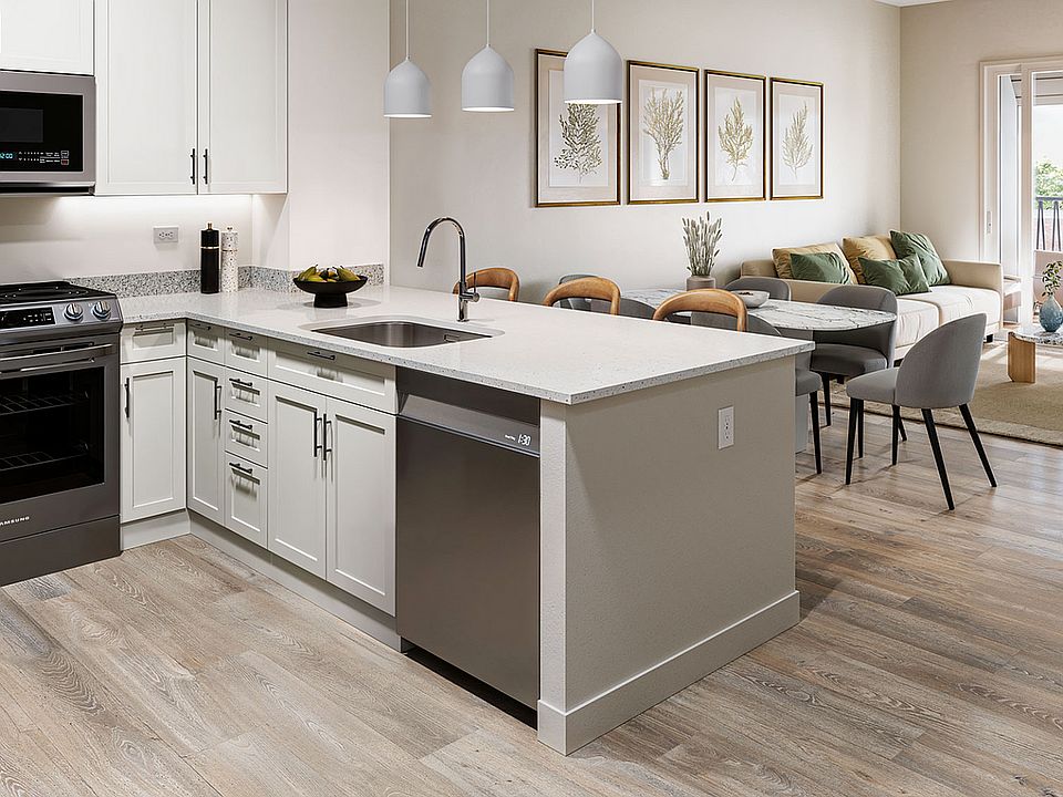 Experience the elegance of this contemporary kitchen and living area designed for modern comfort.