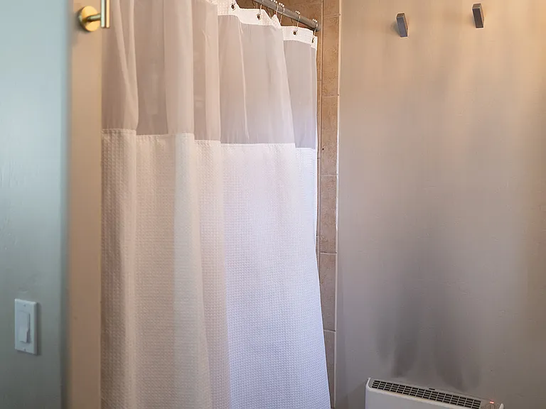 Shower now has a new glass sliding door.