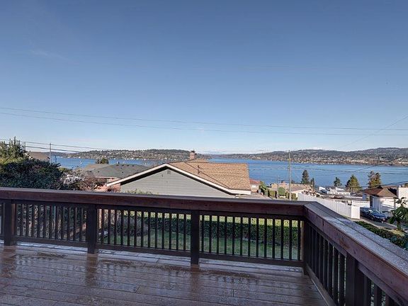 view of Lake Washington from sliding glass door to deck and backyard