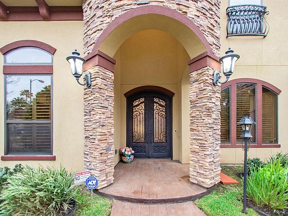 Grand entry with "wood look" pattern concrete, Majestic heavy duty double iron front door