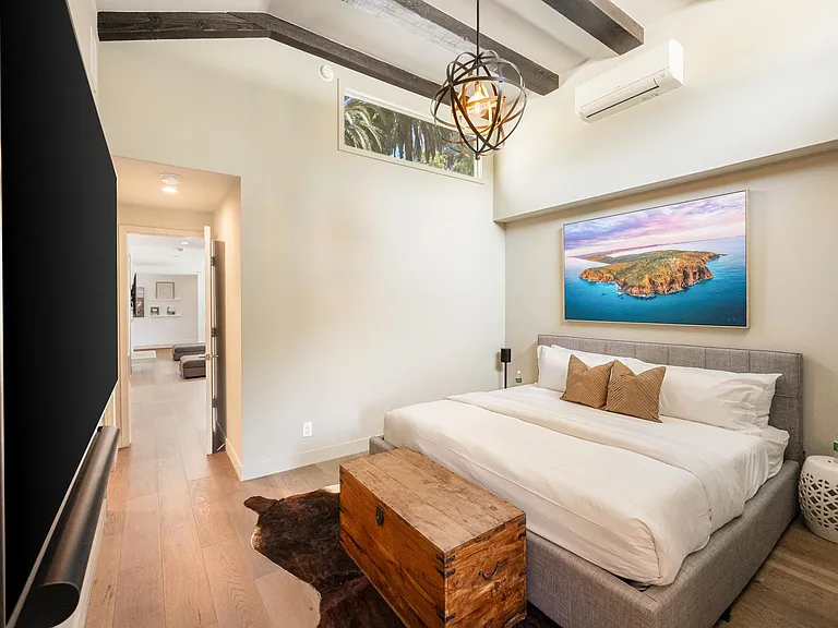 Boasting tall ceilings, the bedroom combines comfort and style for a truly luxurious retreat.