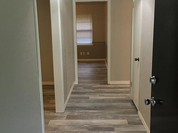 Entry through front door (living area ahead, living area to left, bedrooms to right)