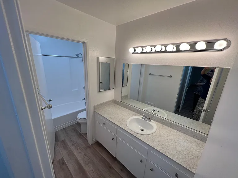 Vanity area looking toward private toilet and tub/shower area. 1x1