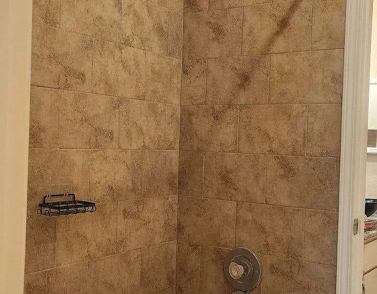 Hollywood Style bath, 1 Bathtub in middle with shower, and 2 vanities & Commodes on each side.