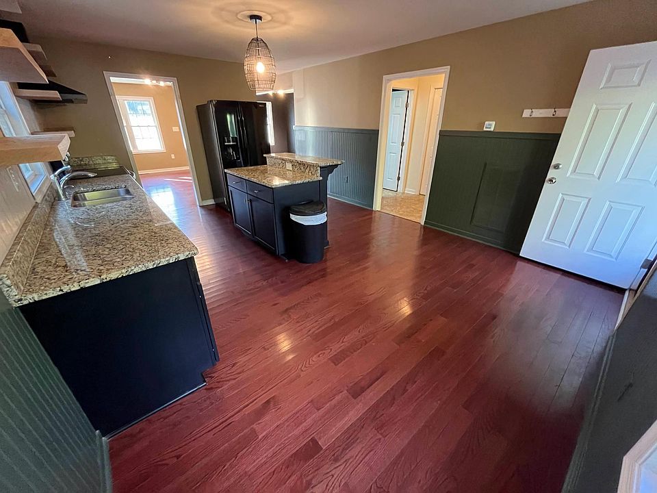 1st Floor - Kitchen with Refrigerator, Oven/Range, Stove, Hood, Garbage Disposal, Island, Open Shelves, Backsplash Tile, Lots of Cabinet Storage