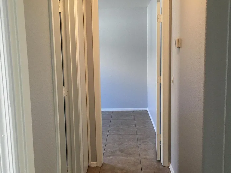 With this split floor plan, the master is on one side of the family room and the other two bedrooms and bathroom are on the other side. This is the hallway between the two bedrooms.