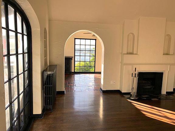 Arched enrty into a spacious dining room, hardwood floors, Spanish tiled dining room floor, west views of Lake Union.