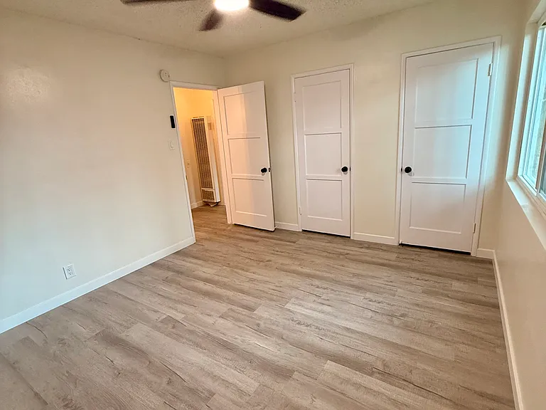 Spacious Bedroom with Dual Walk In Closets, New Dual Pane Windows for Noise and Weather Insulation, New Flooring, New Hardware, New Bluetooth Fan with adjustable lighting, and Blackout Window Treatments...Comfort!