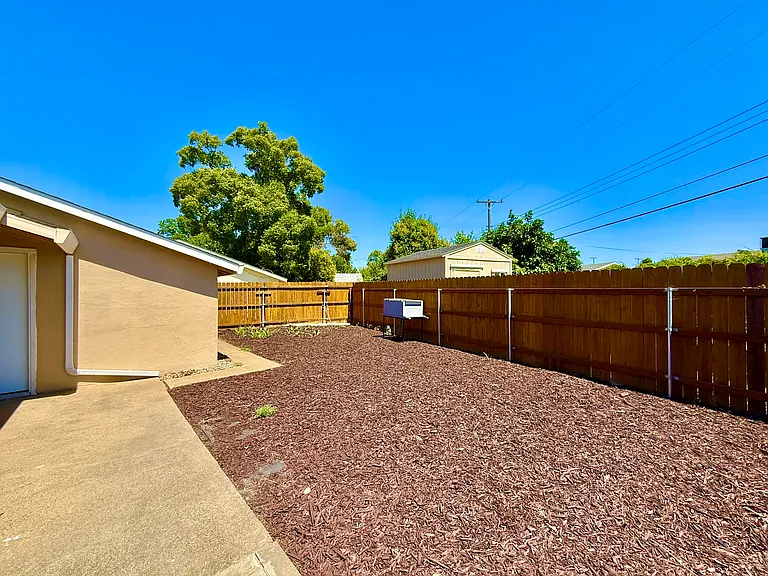Backyard with back door leading into garage
