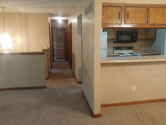VIEW OF KITCHEN AND HALLWAY LEADING TO BEDROOMS