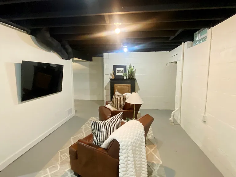 The downstairs game room boasts a 55-inch smart TV with an HDMI wall plug for easily connecting your video game console. Cabinet is stocked with puzzles and board games for your entertainment.