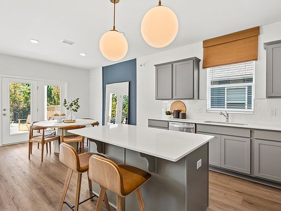 Beautiful Open Kitchen with an island and natural gas stainless steel appliances.
