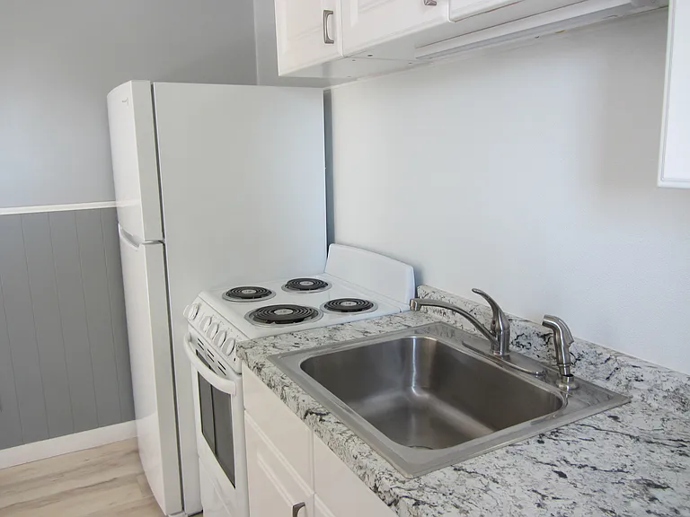 Kitchen with new stove and refridgerator.