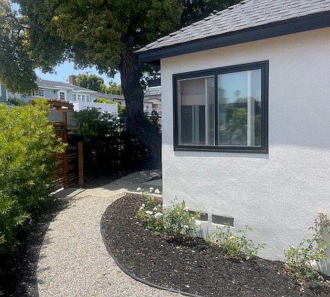 Exterior front yard with new landscaping leading to front door and side patio