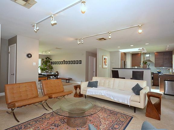 Alternate view of Family Room which boasts Porcelain tile flooring, soft neutral colors, French Door