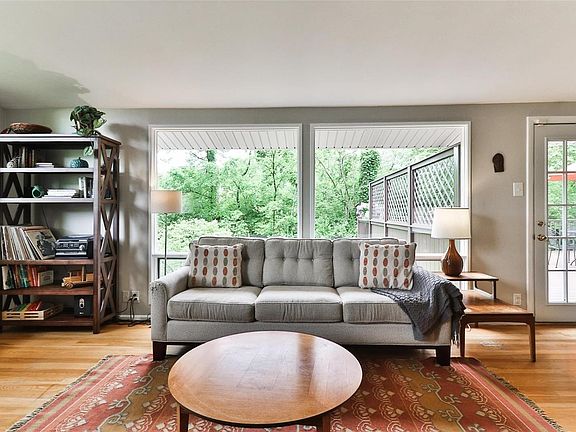 Another view of the living room with a wall of windows letting in the natural light.