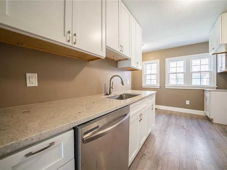 Brand new shaker cabinets granite countertops, hardwood flooring and dishwasher