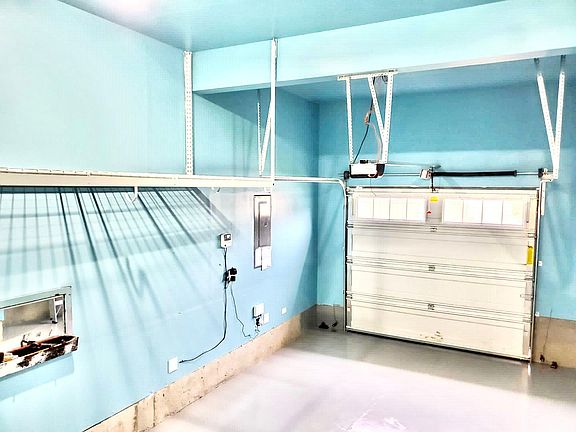 Epoxy floor garage with over the head storage.