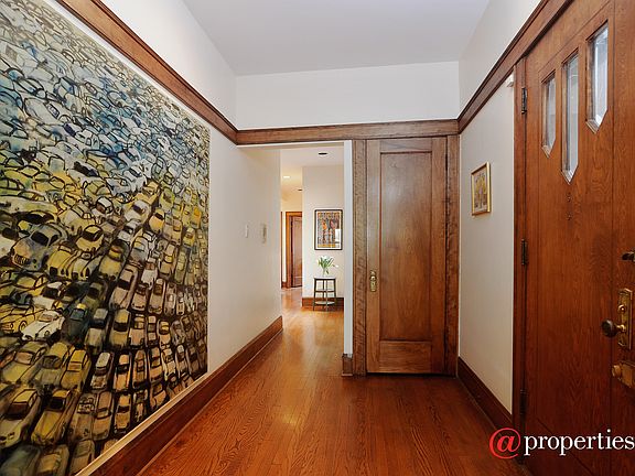 foyer with beautiful original molding & doors