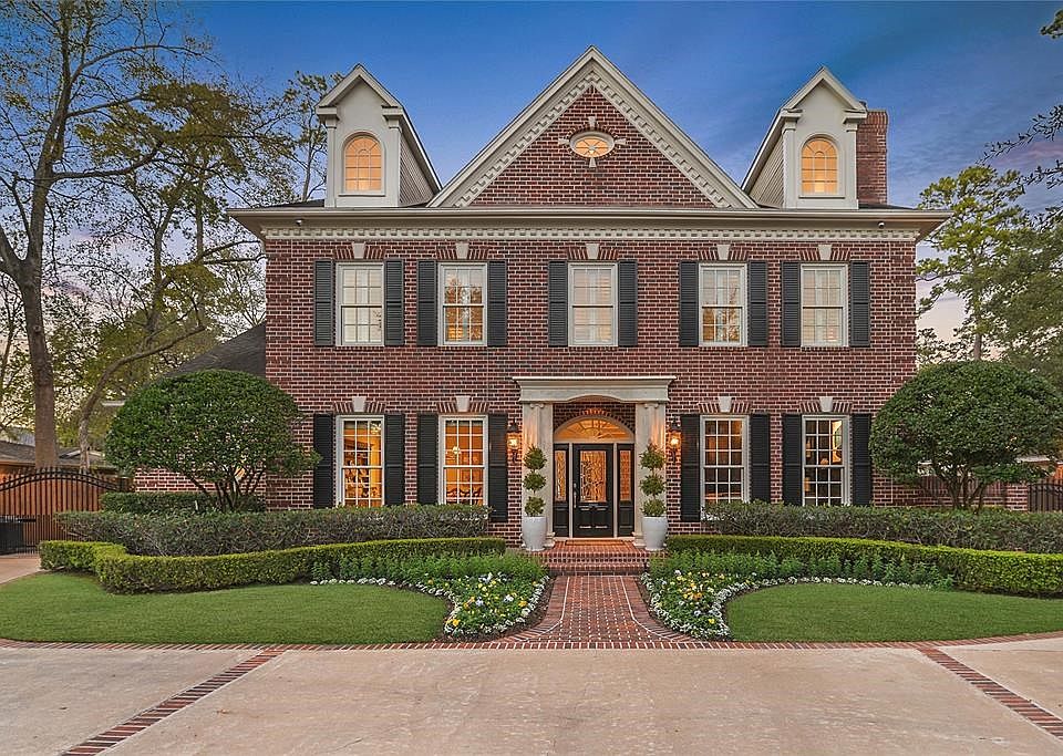 Polished landscaping elevates the curb appeal of this beautiful home.  Private wrought iron gate provides access to the two car garage from the circular driveway.